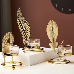 golden leave candle holder lifestyle shot with eagle wing and feather leaf design repeat