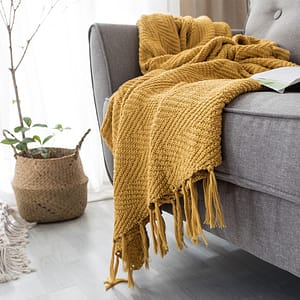 mustard yellow throw blanket on grey sofa lifestyle shot repeat