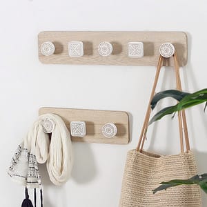 nordic geometric wooden wall hooks decoration details lifestyle with scarf and bag