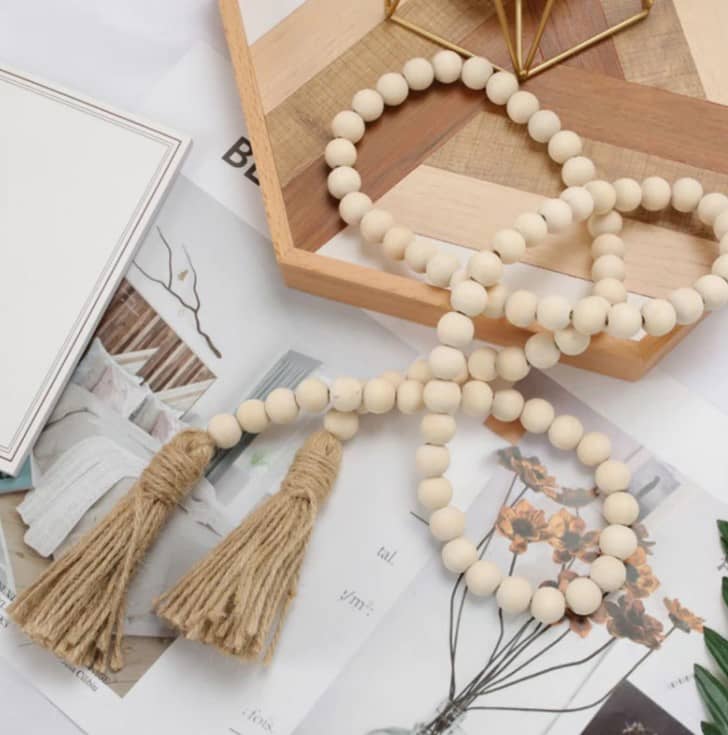 beads with beige tassels with wooden tray